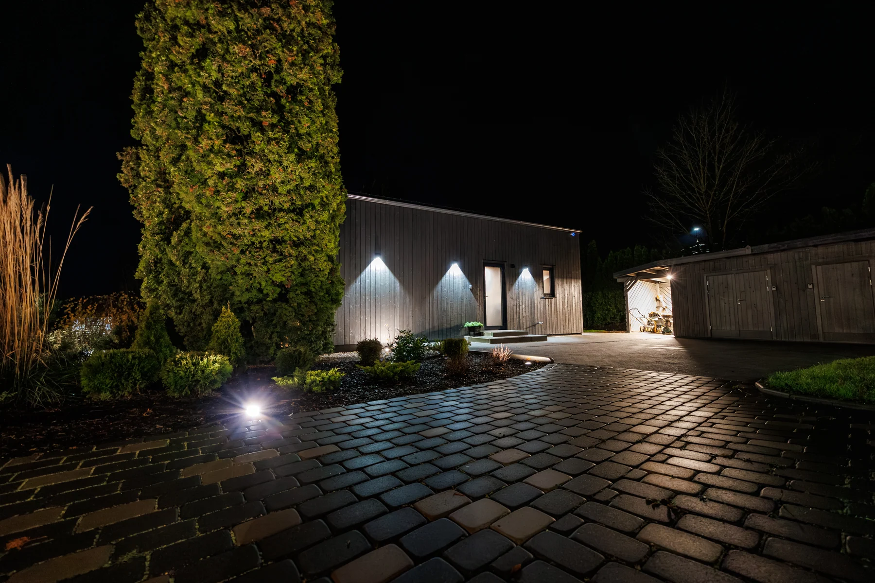 Architectural home illuminated against an evening sky